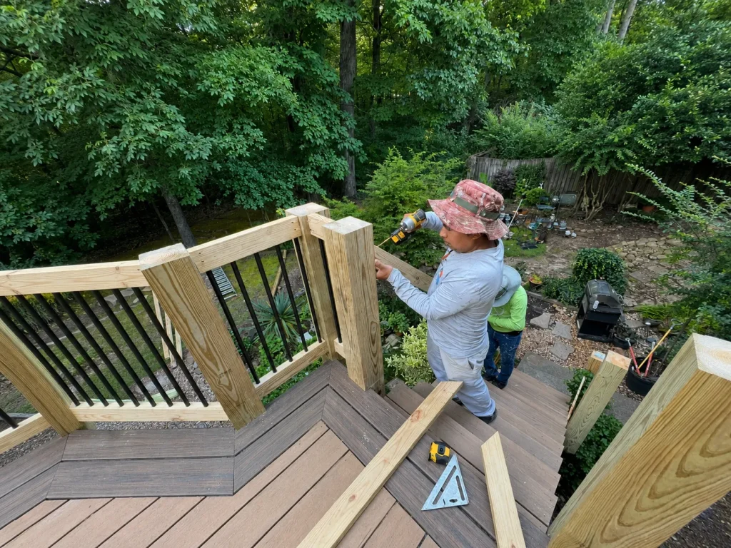 Contractor building stairs and railings for a two-tone composite deck in Indianapolis