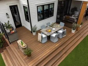 Multi-level brown composite deck with dining area and wide wraparound steps in Indianapolis