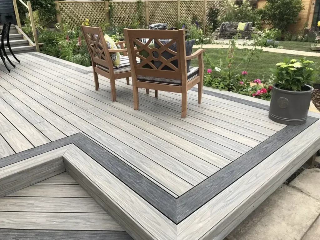Light gray floating composite deck with dark picture-frame border in an Indianapolis garden