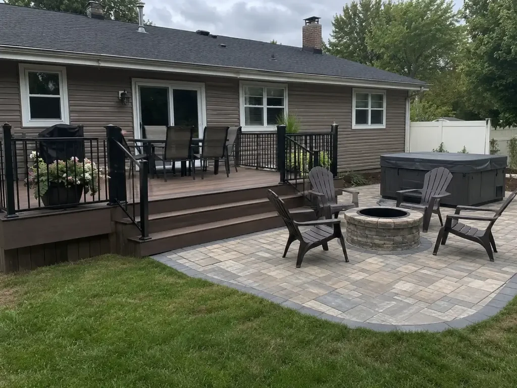 Raised deck connected to a paver patio with fire pit and hot tub in Indianapolis, IN