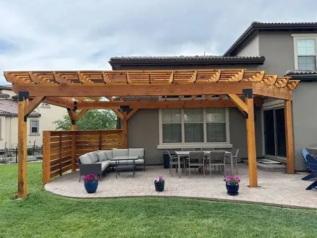 Custom wood pergola covering a paver patio with dining and lounge furniture in Indianapolis