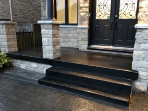 Black stone front porch steps with masonry columns at an Indianapolis home