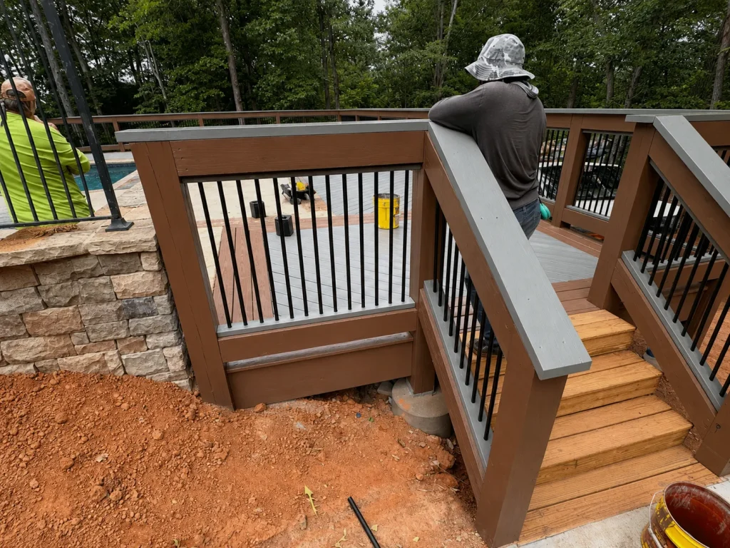 Contractor installing wood railings and stairs on a residential deck in Indianapolis