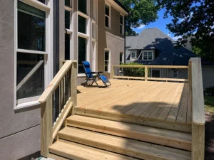 New pressure-treated wood deck with wide stairs at an Indianapolis home